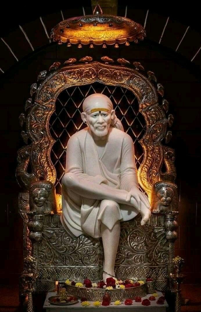 Sai Baba seated on a golden throne