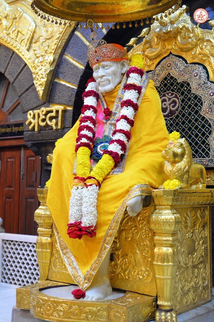 Sai Baba seated on golden throne