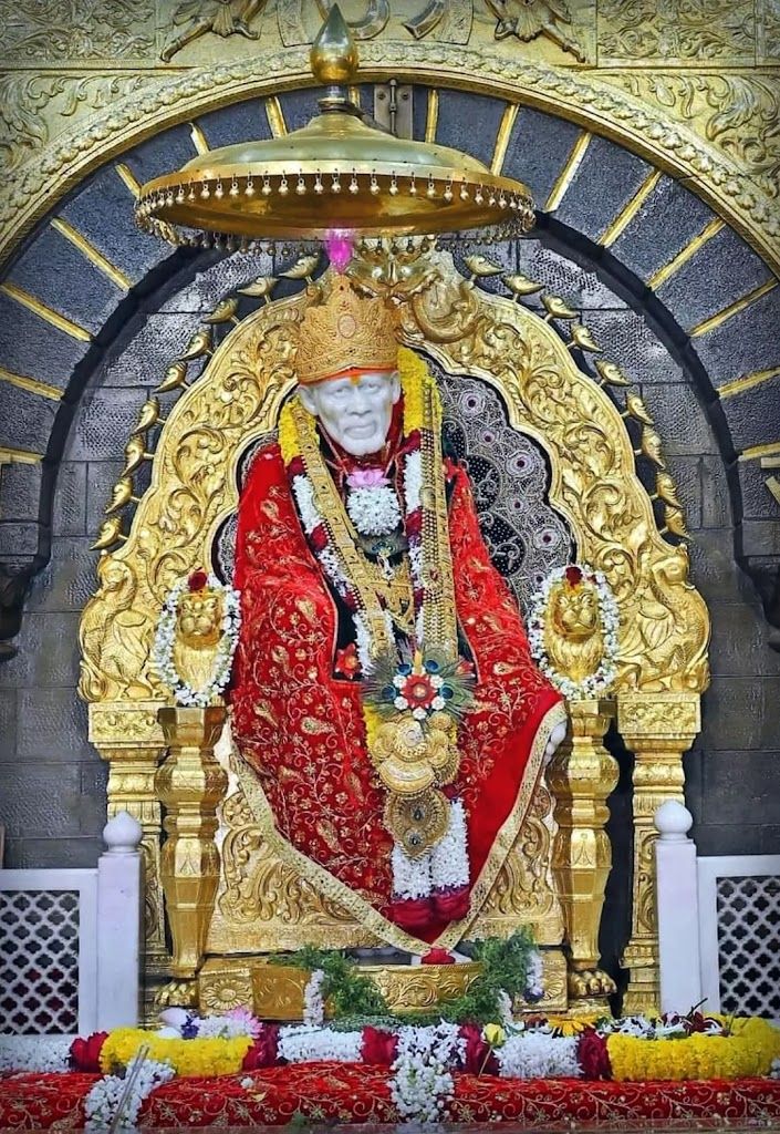Sai Baba seated in golden shrine