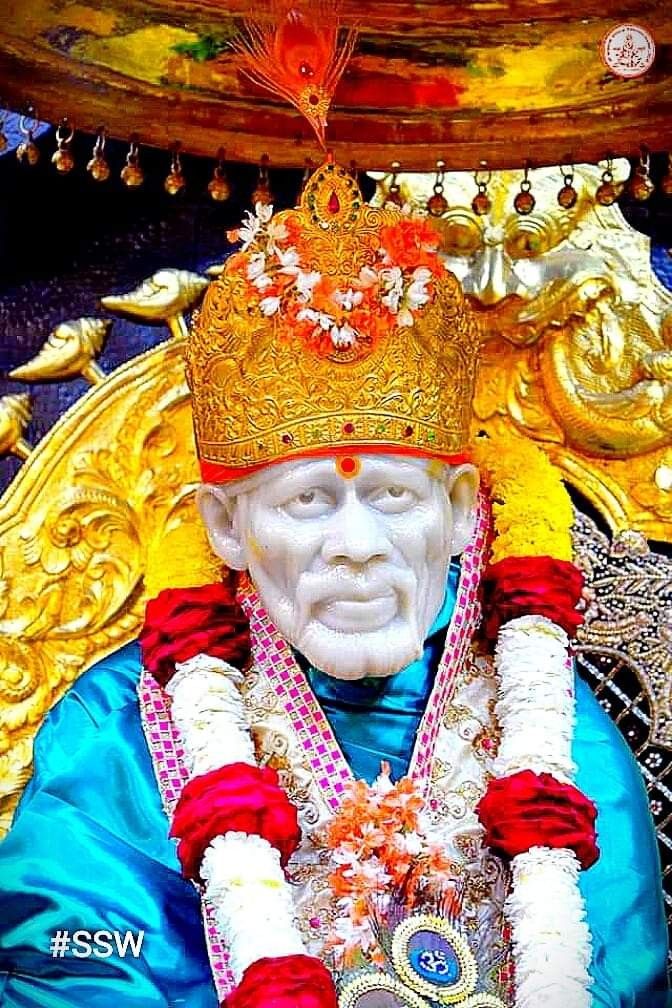Sai Baba with golden crown and flowers