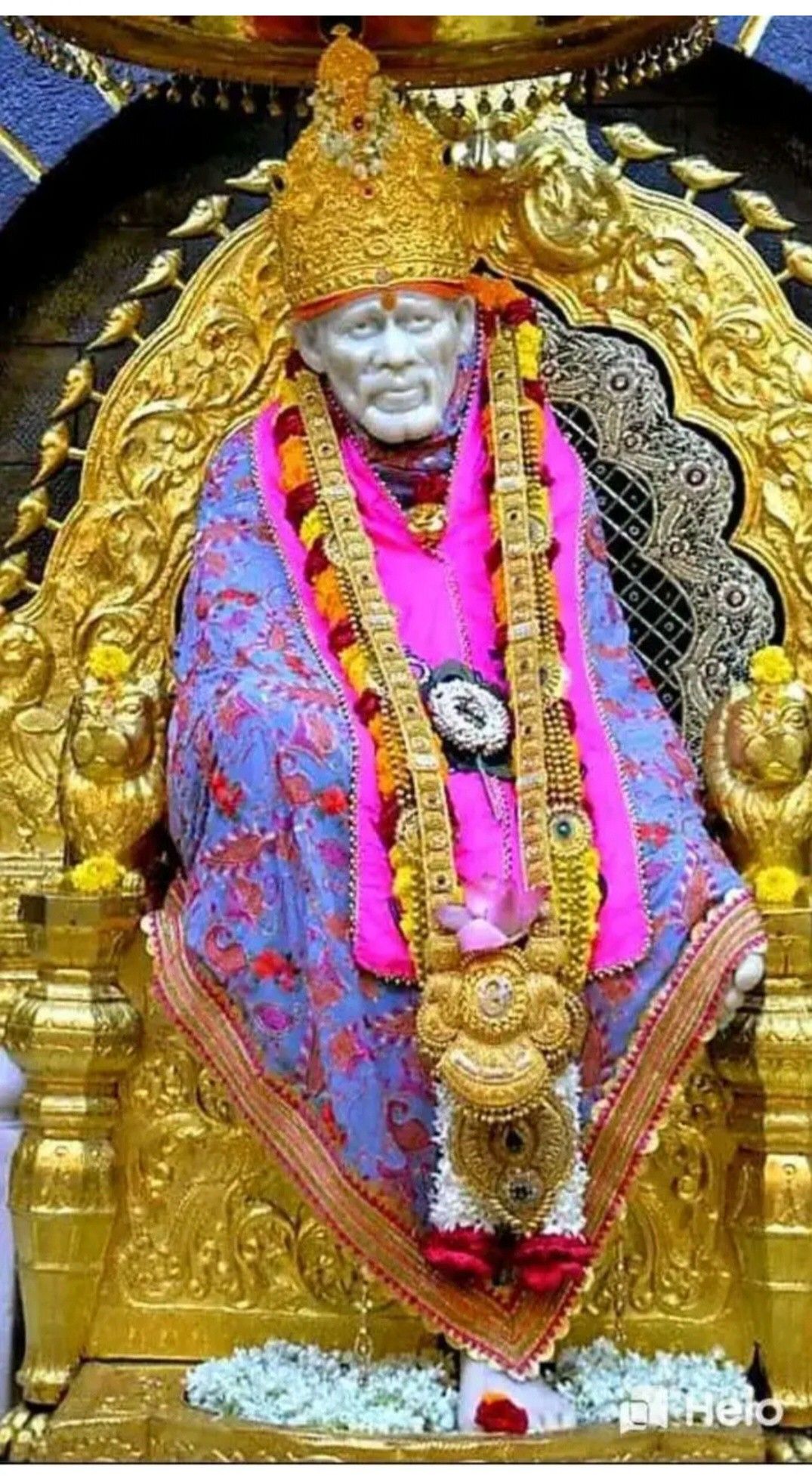 Sai Baba seated on a golden throne