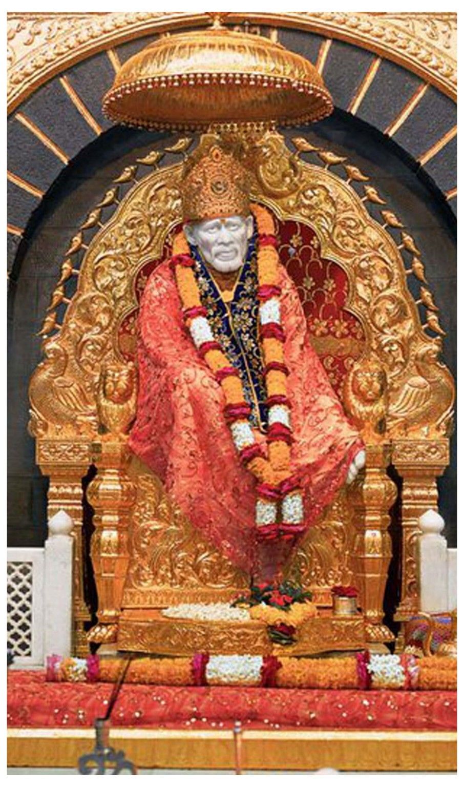 Sai Baba seated on a golden throne