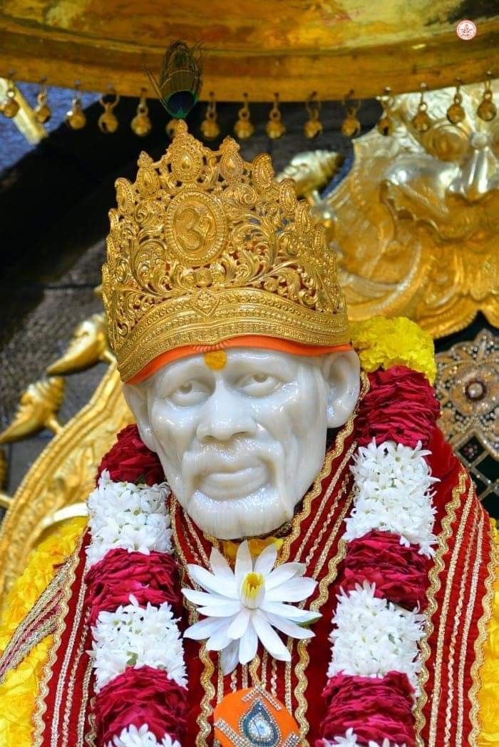 Sai Baba idol adorned with flowers