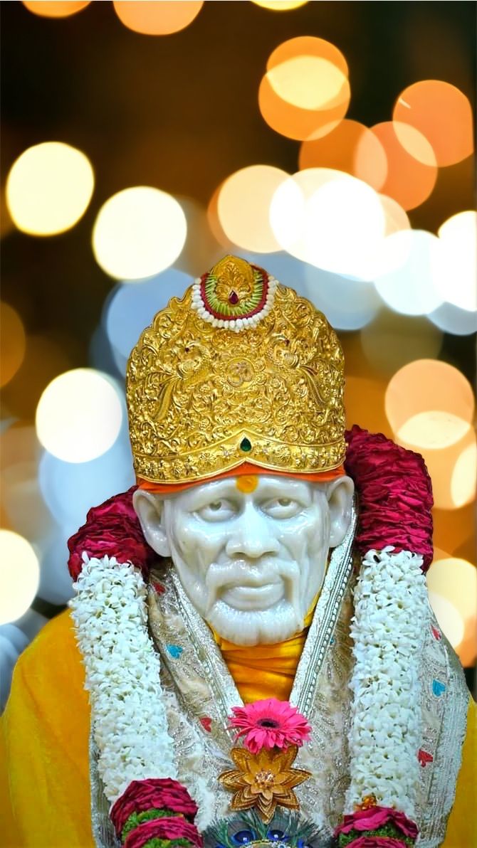 Sai Baba with golden crown and flowers
