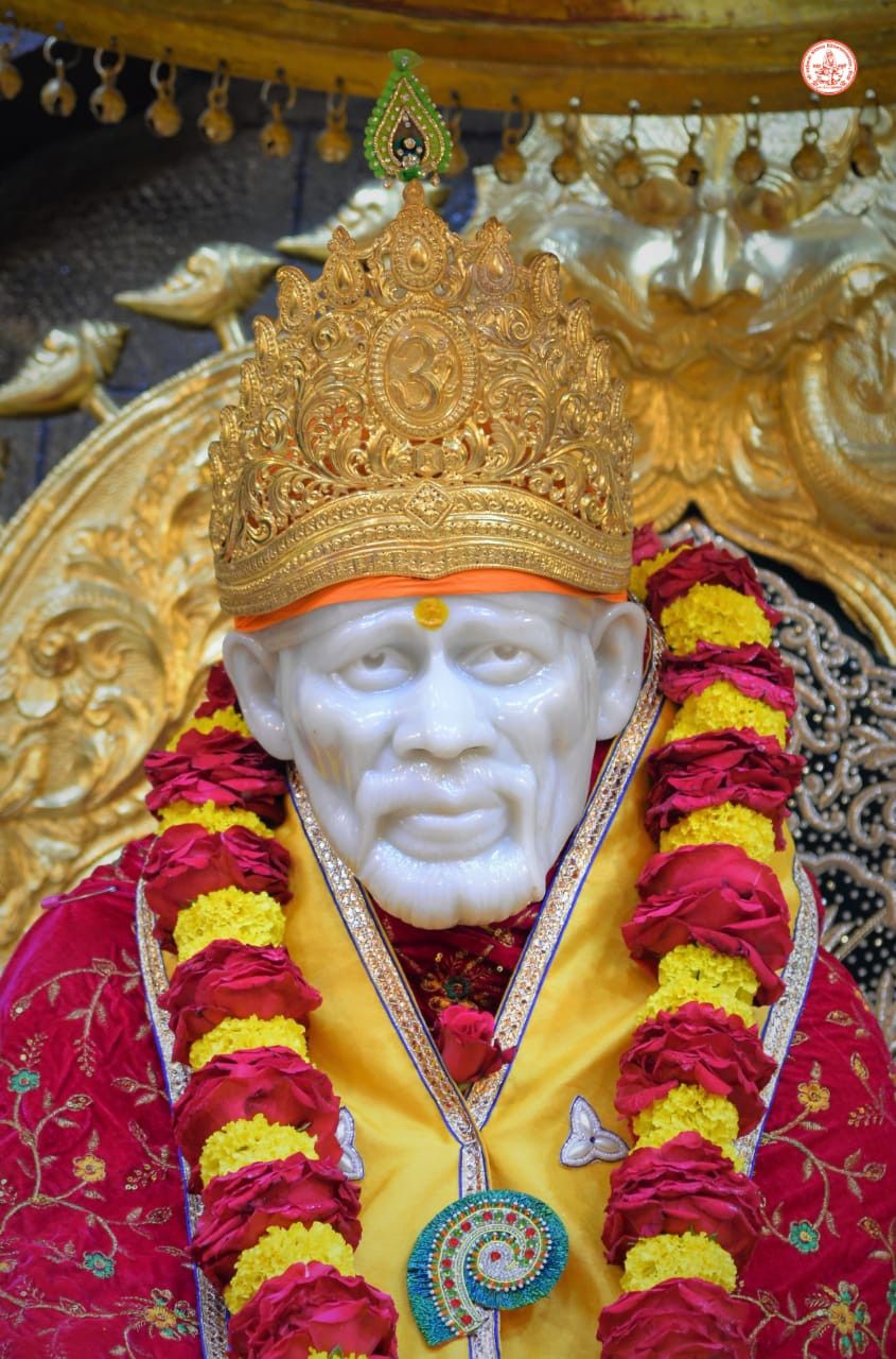 Sai Baba with golden crown and flowers