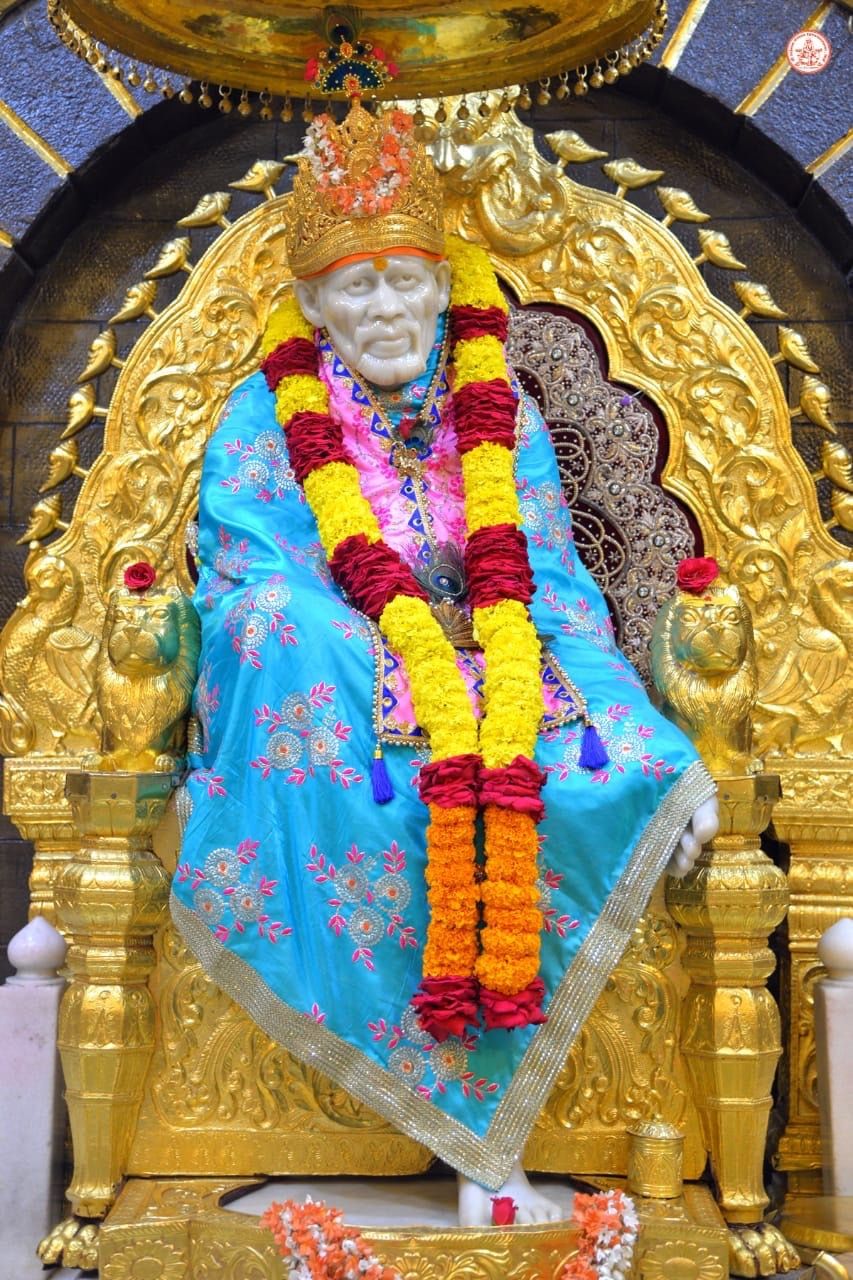 Sai Baba seated on golden throne