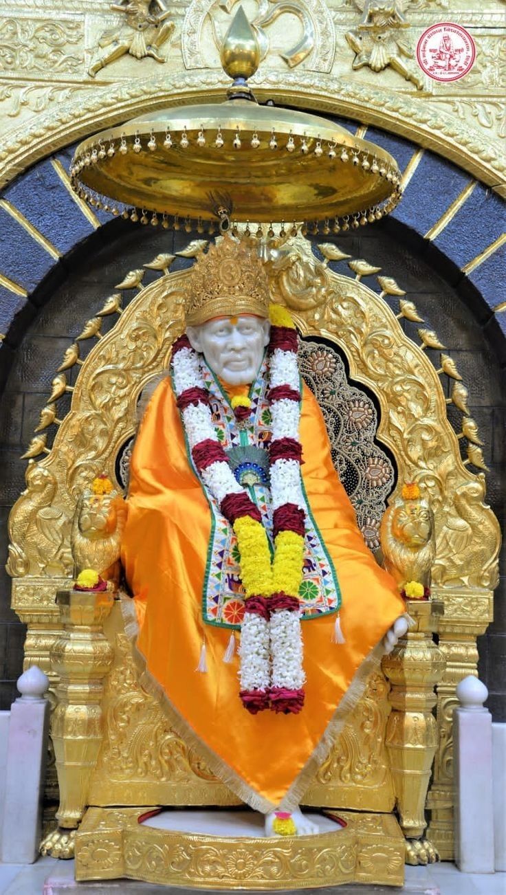 Sai Baba seated on golden throne