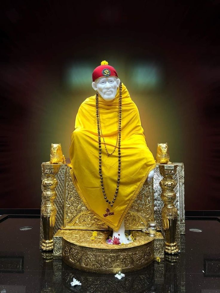 Sai Baba seated on golden throne