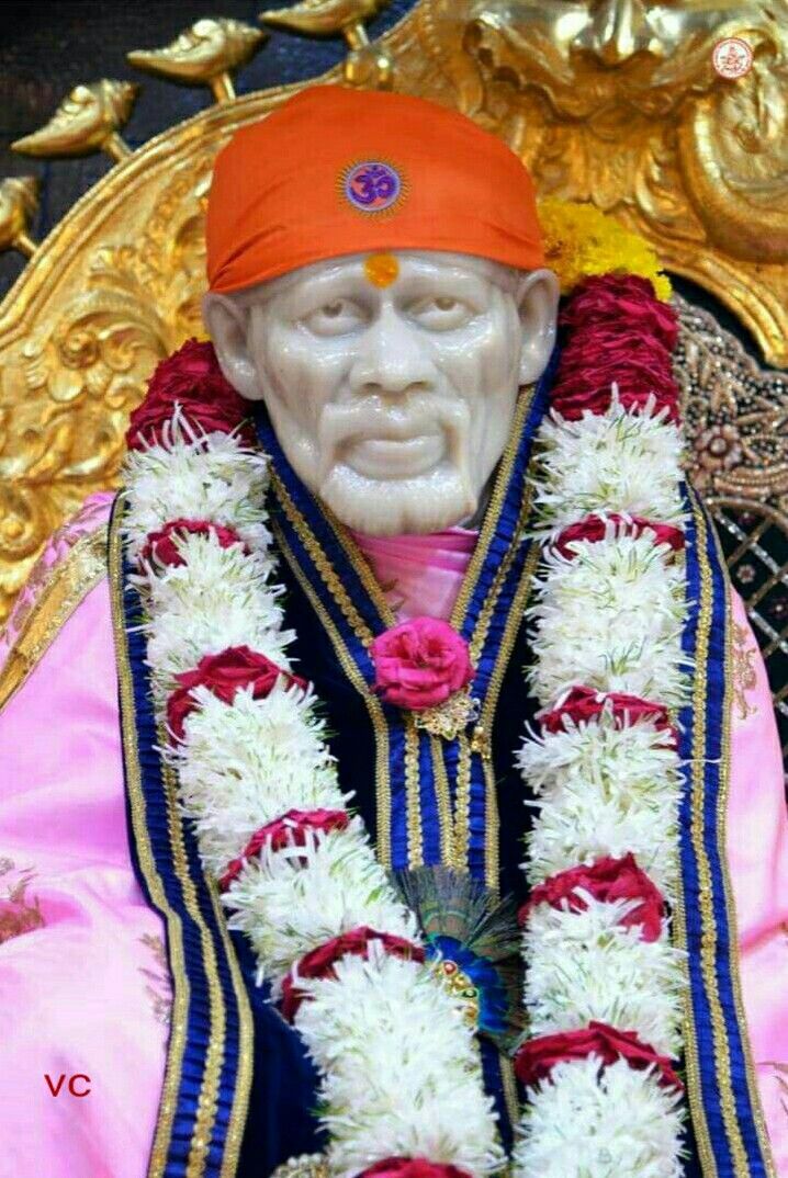 Sai Baba idol with floral garland