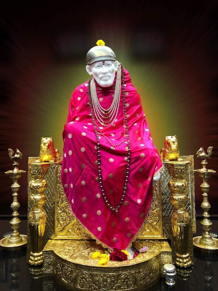 Sai Baba seated on golden throne
