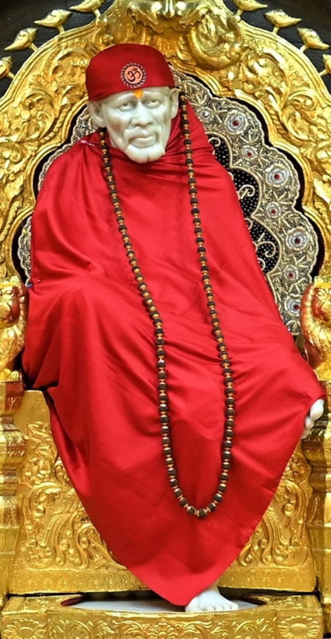 Sai Baba seated on golden throne