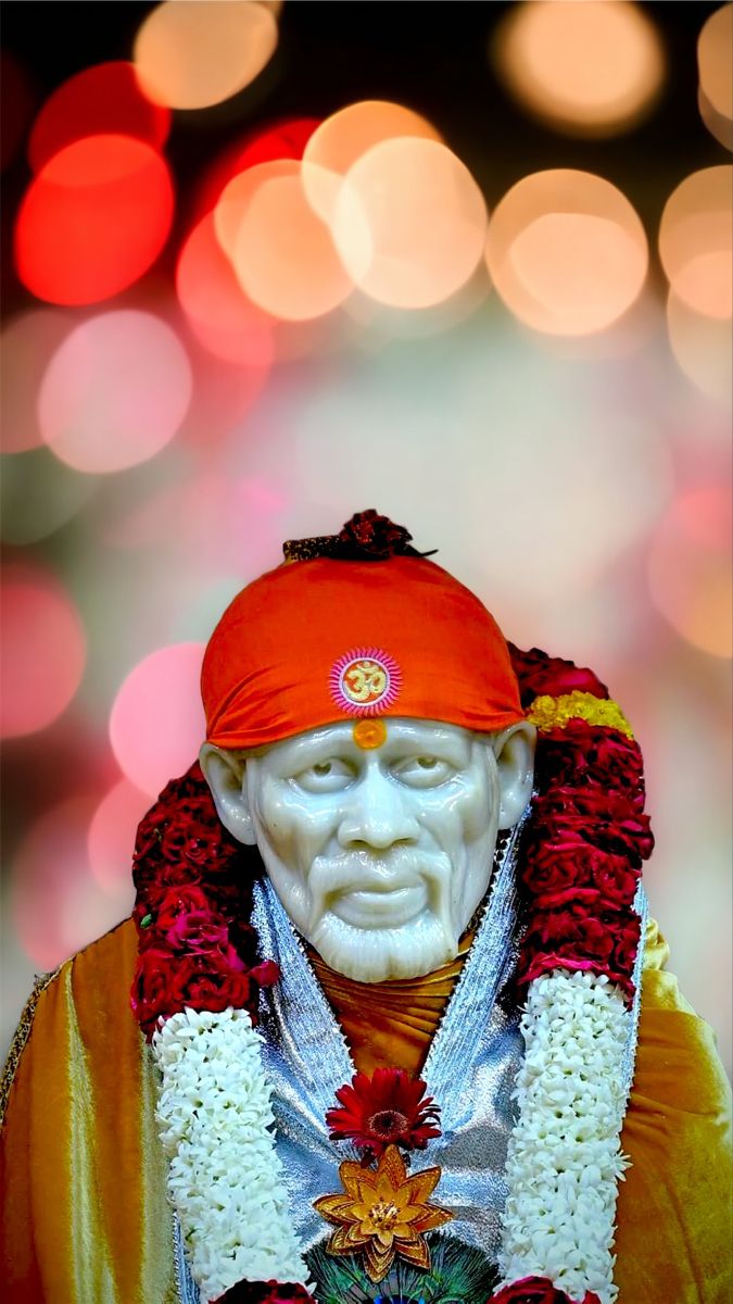Sai Baba with floral garland.