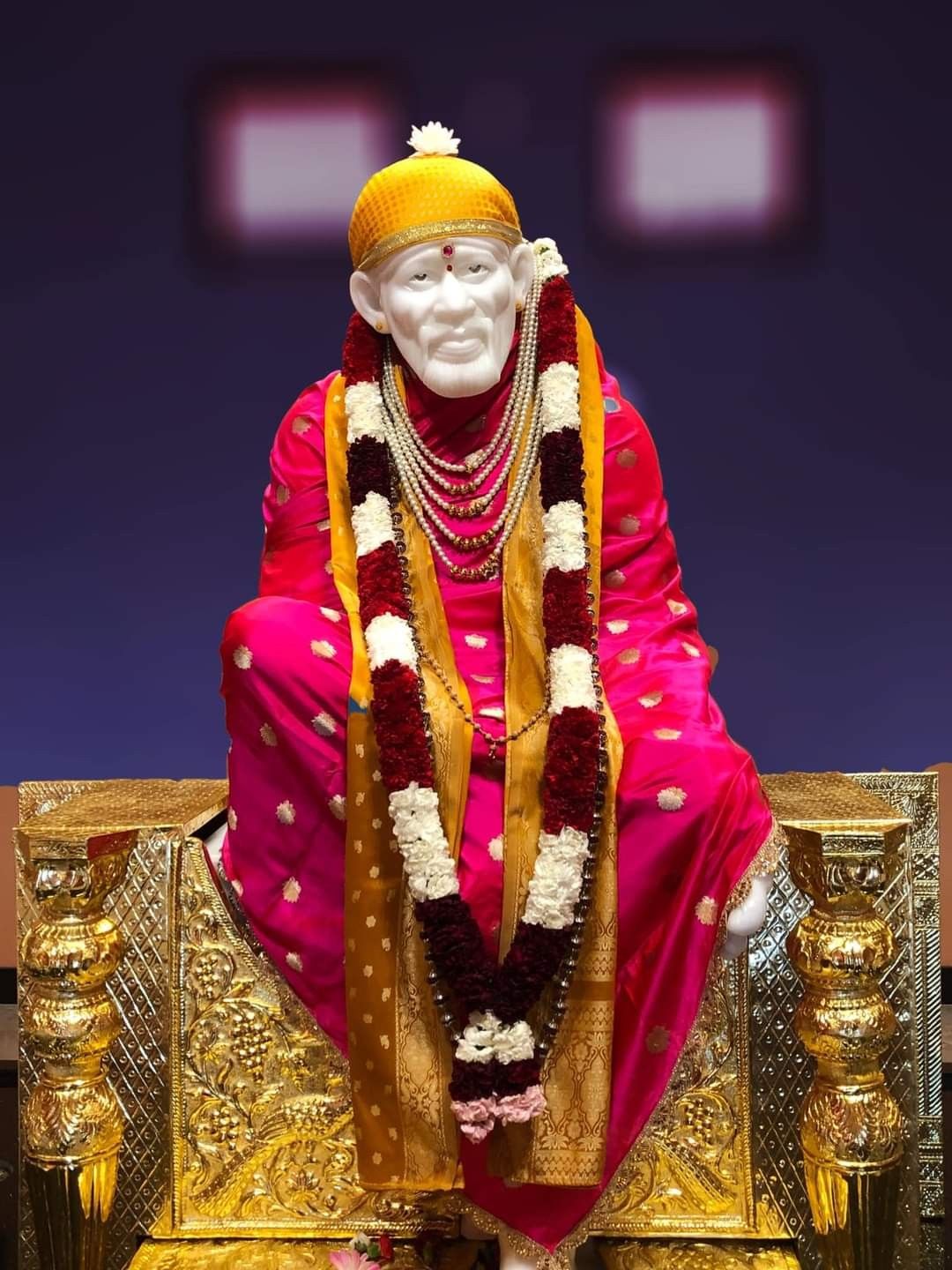 Sai Baba seated on golden throne