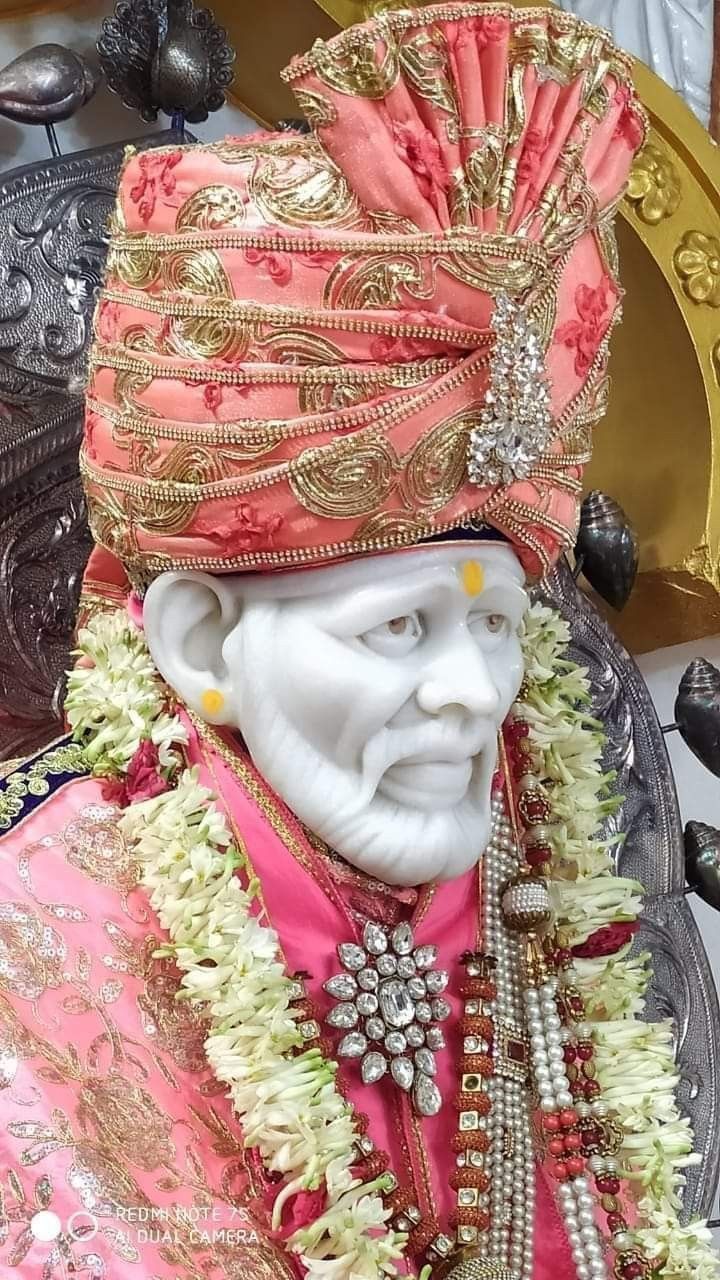 Sai Baba adorned with flowers.