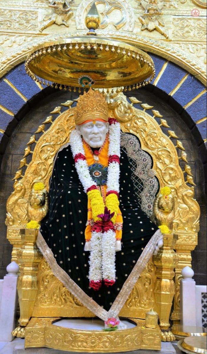 Sai Baba seated on golden throne