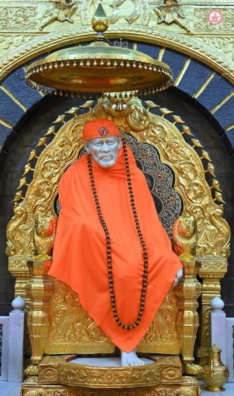 Sai Baba seated on golden throne