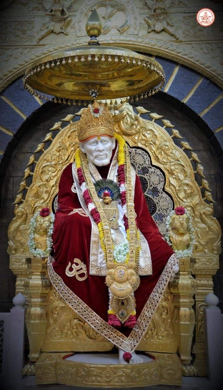Sai Baba seated on a golden throne