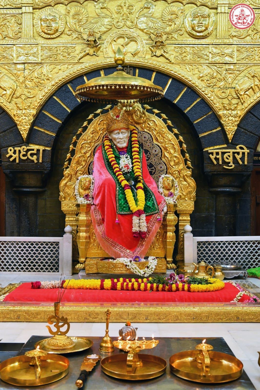 Sai Baba seated on golden throne