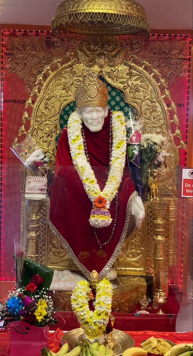 Sai Baba idol with floral offerings