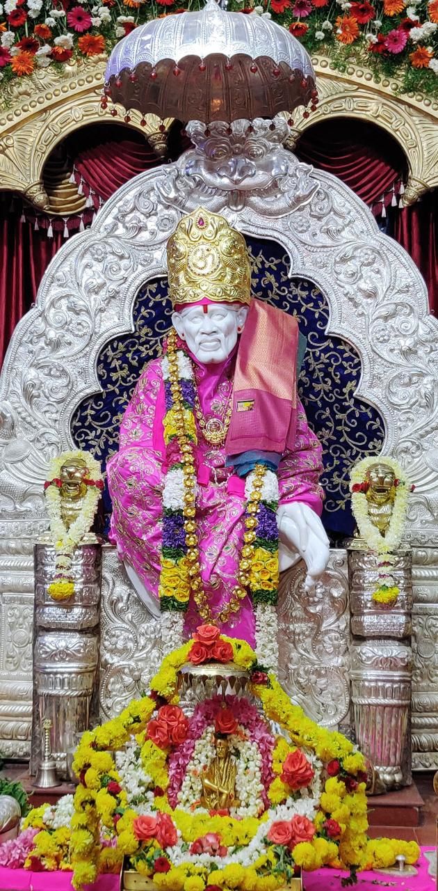 Sai Baba idol with floral offerings