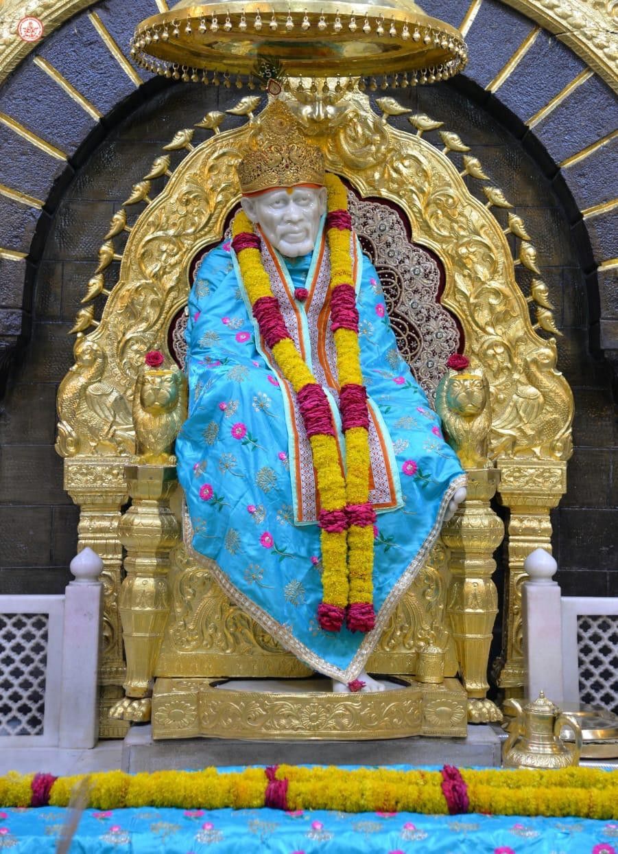 Sai Baba seated on golden throne