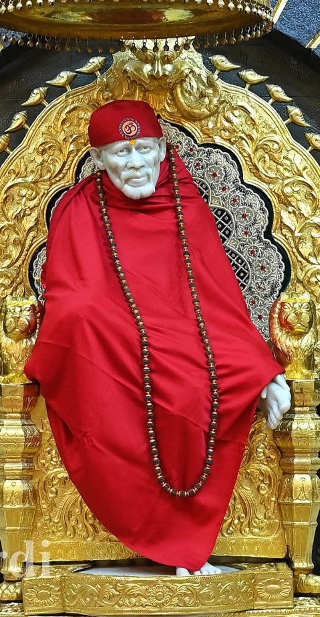 Sai Baba seated on golden throne