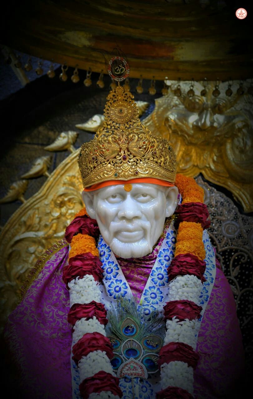 Sai Baba with flower garland and crown
