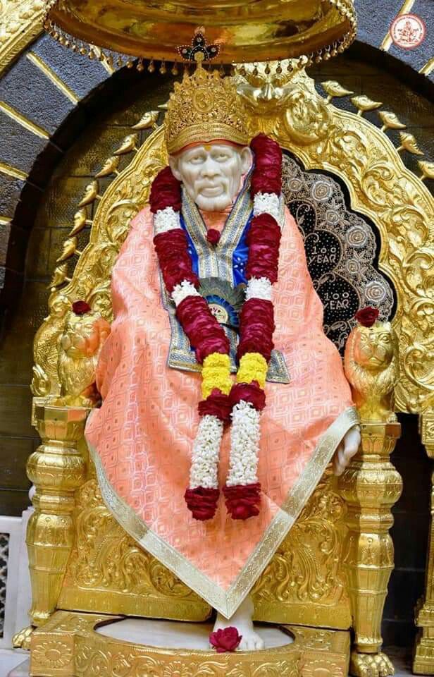 Sai Baba on golden throne.