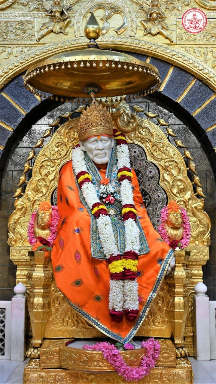 Sai Baba seated on golden throne
