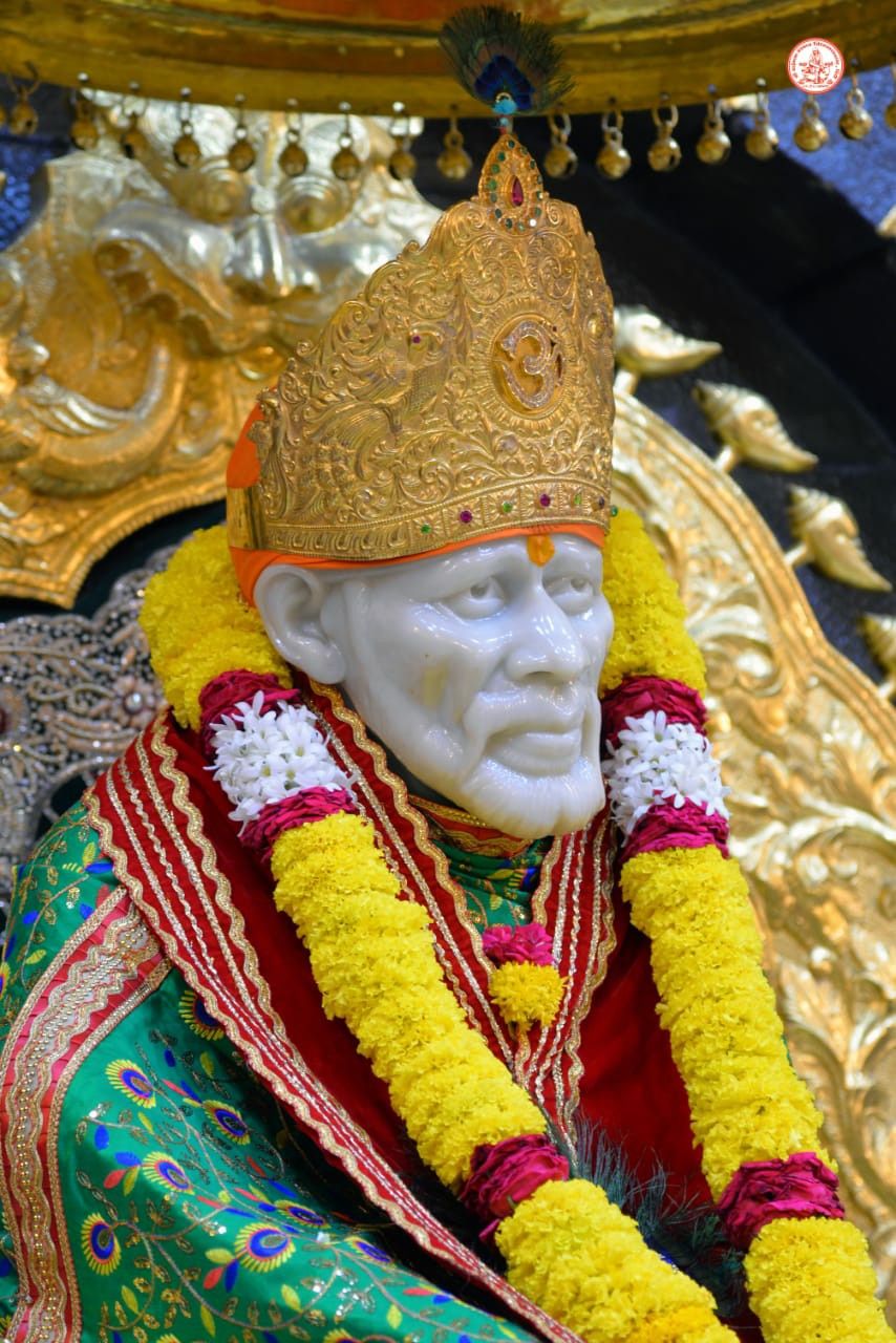 Sai Baba adorned with marigolds