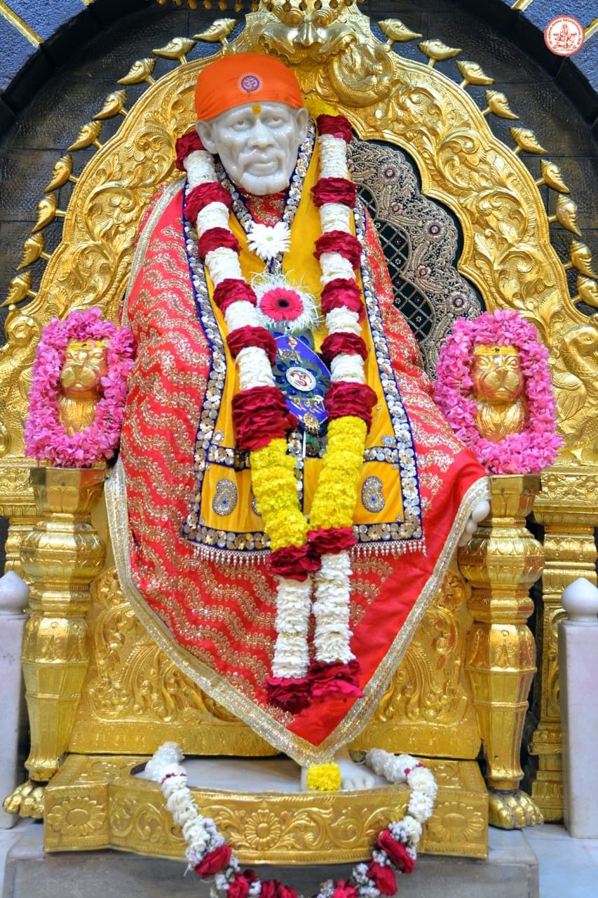 Sai Baba seated on golden throne.