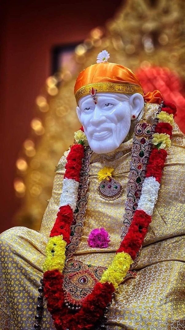 Sai Baba statue with flower garland.