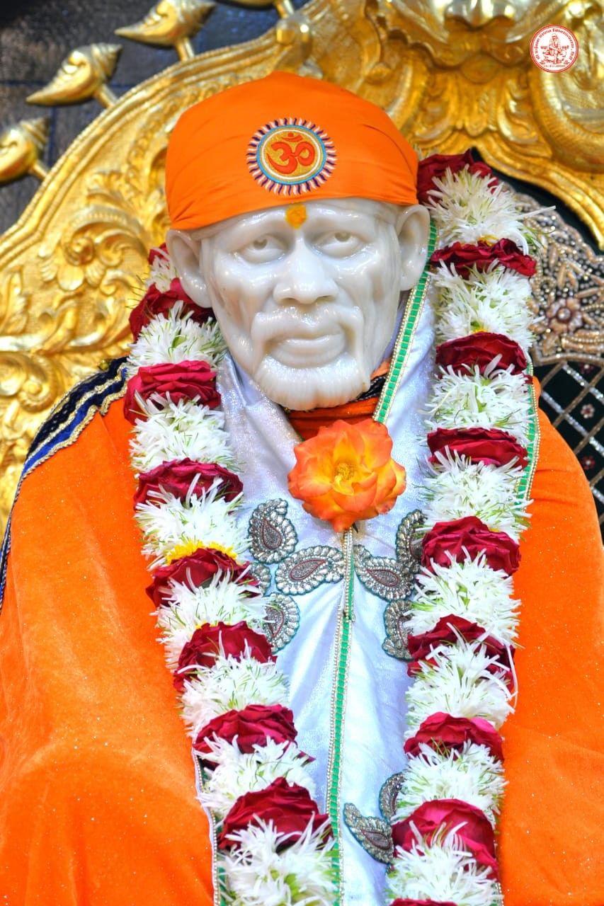 Sai Baba with orange turban and flowers