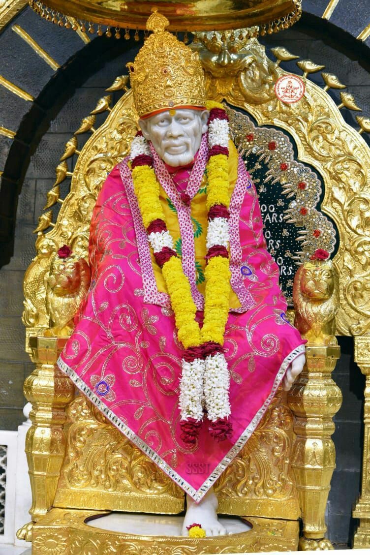 Sai Baba statue adorned with flowers