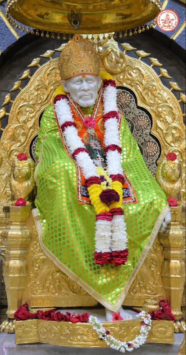 Sai Baba seated on golden throne.