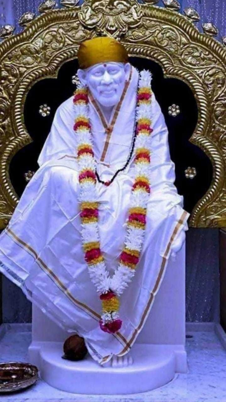 Sai Baba statue with floral garland