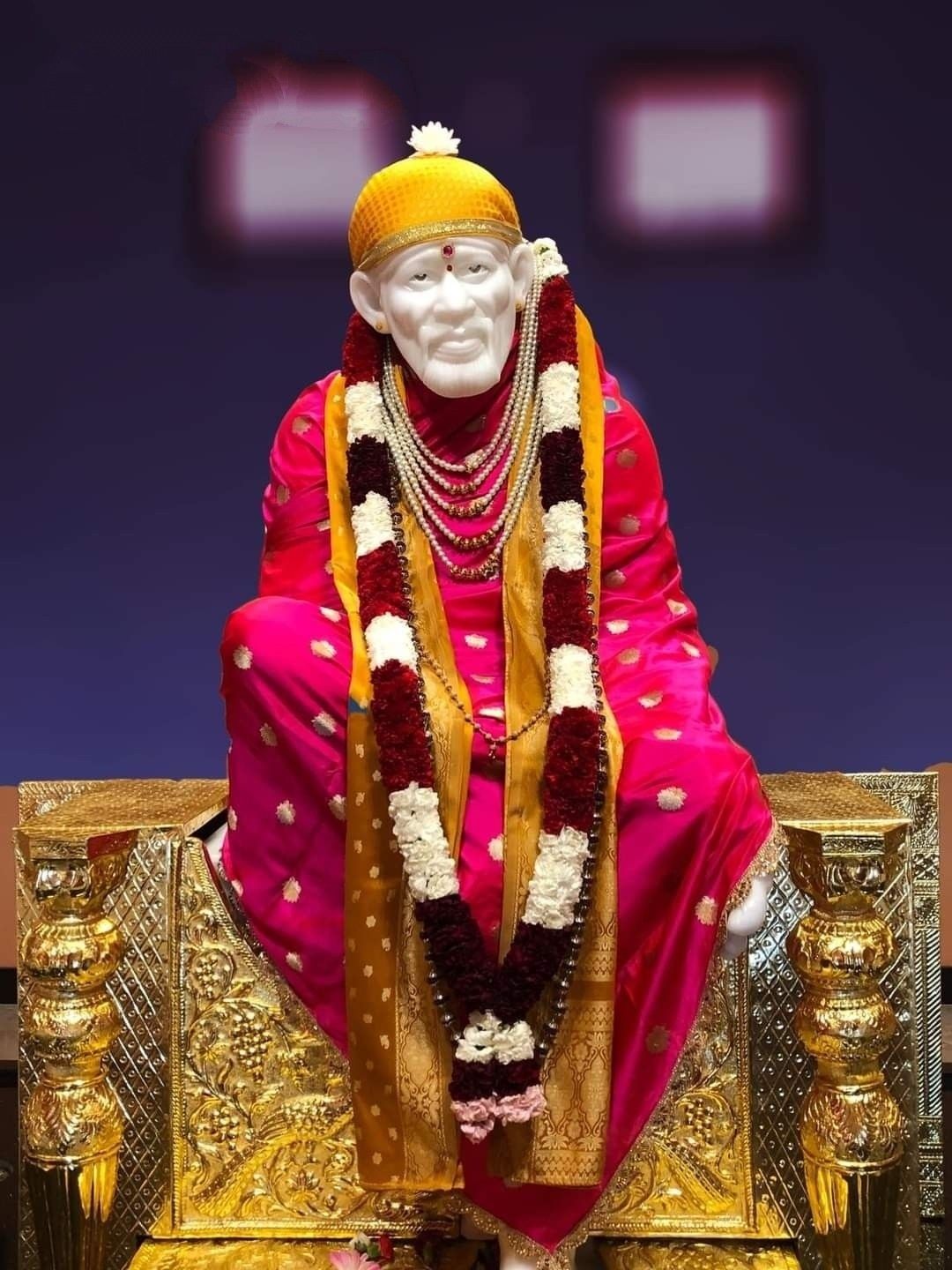 Sai Baba seated on golden chair