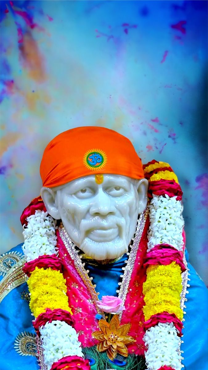 Sai Baba with orange turban and flowers
