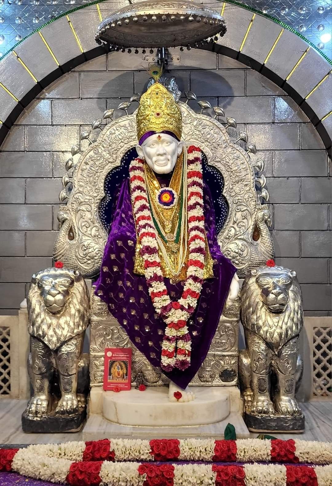 Sai Baba seated on a throne