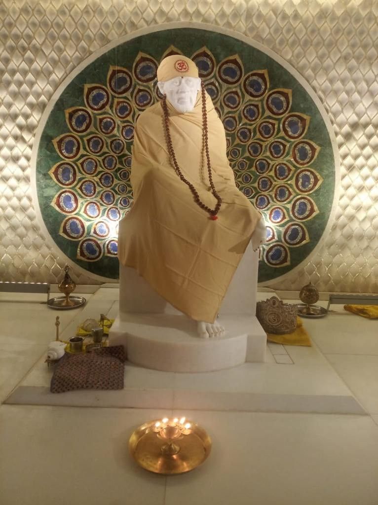 Sai Baba statue in serene temple setting