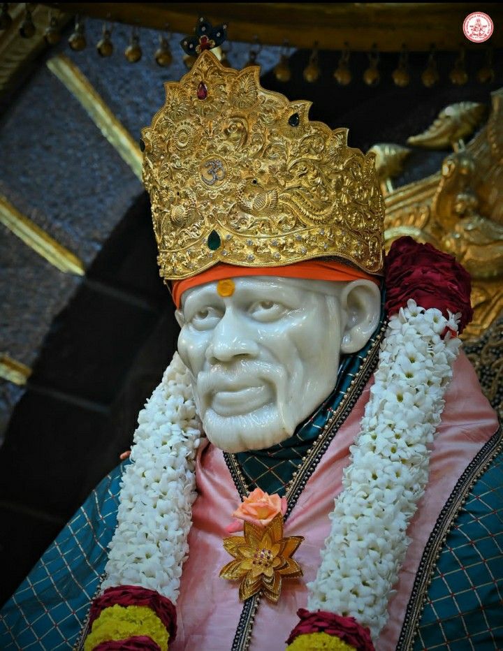 Sai Baba with golden crown, serene face.