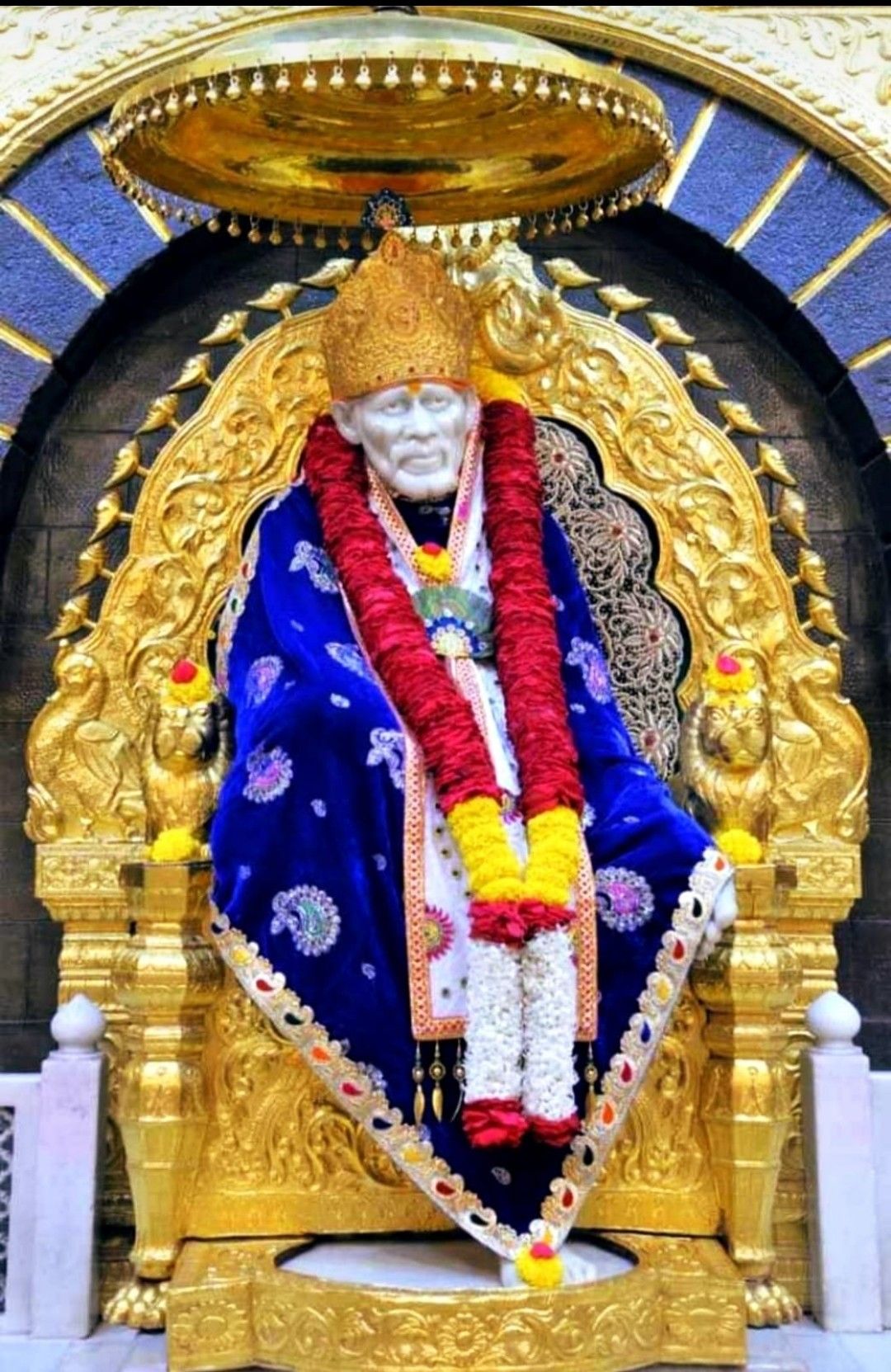 Sai Baba seated on a golden throne