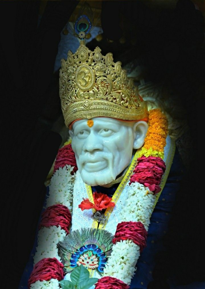 Sai Baba with crown and flowers