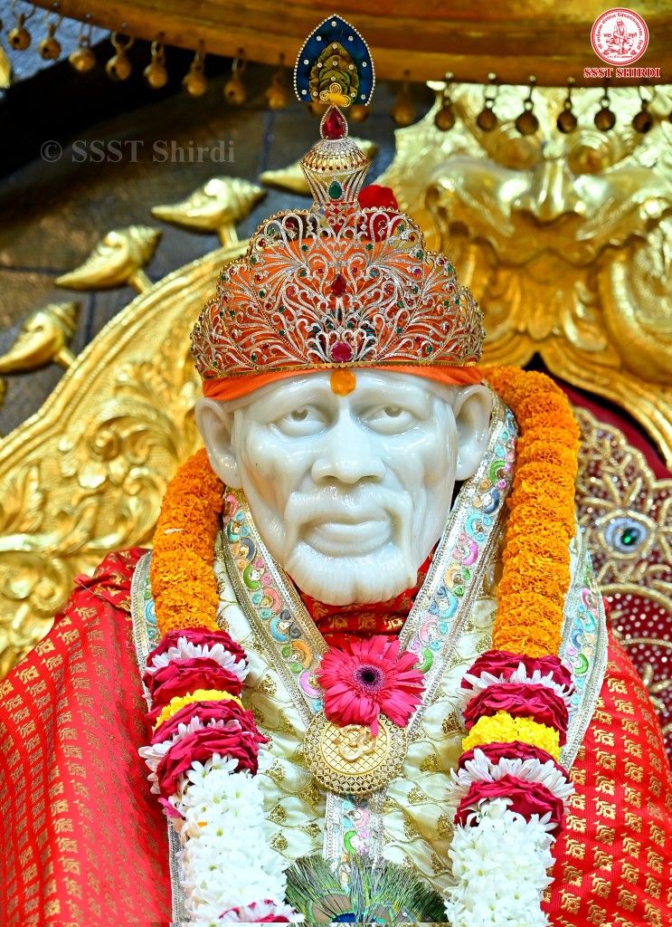 Sai Baba statue adorned with flowers