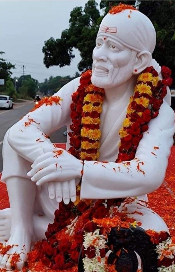 Sai Baba statue with flower garland