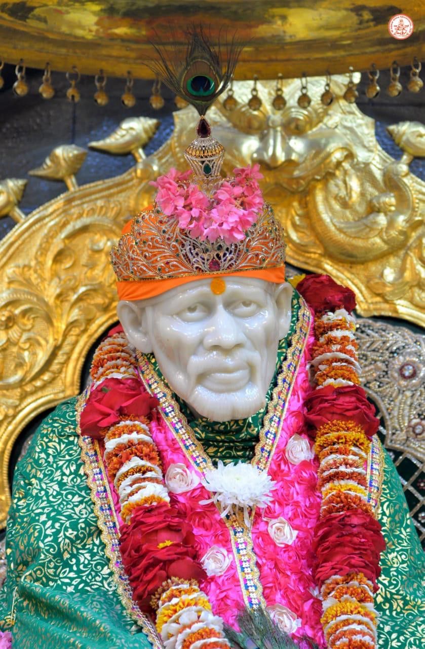 Sai Baba seated in a golden chair