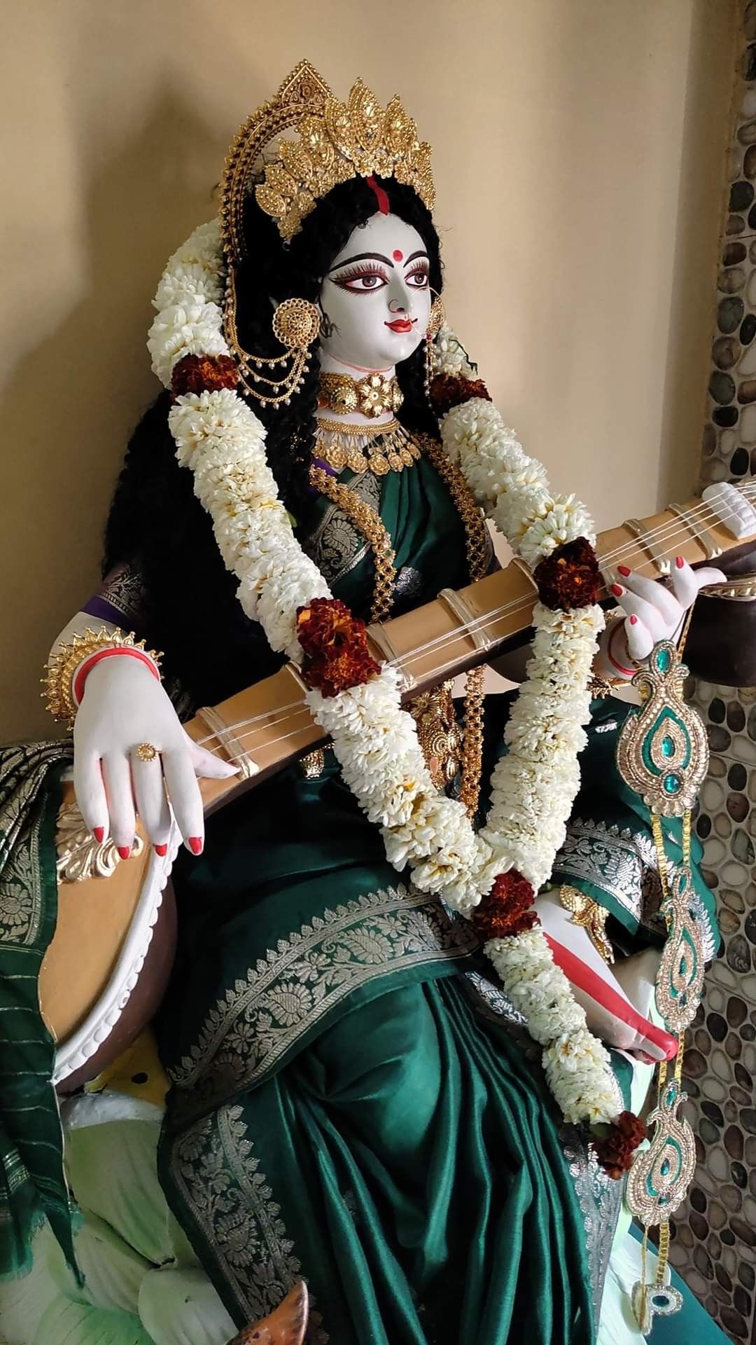 Goddess Saraswati playing the veena
