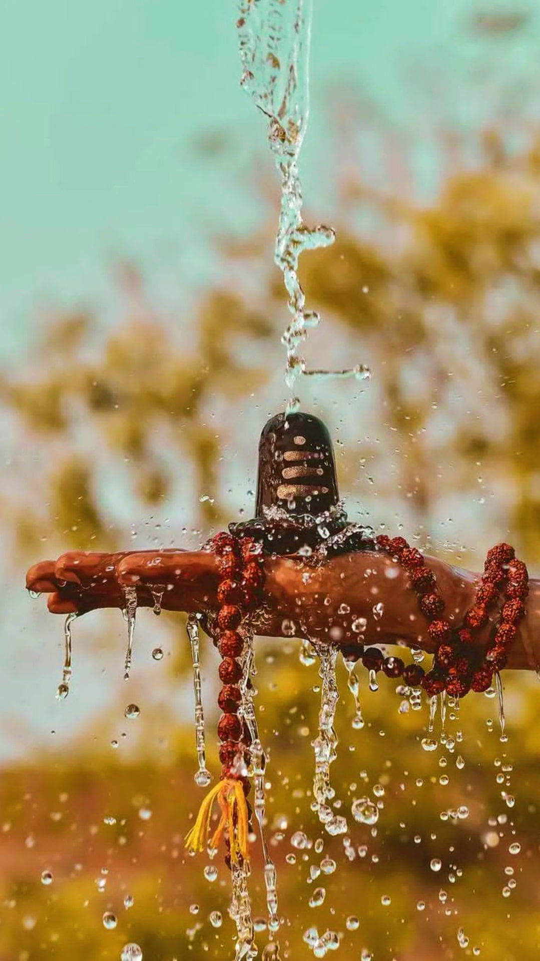 Shivling adorned with flowing water.
