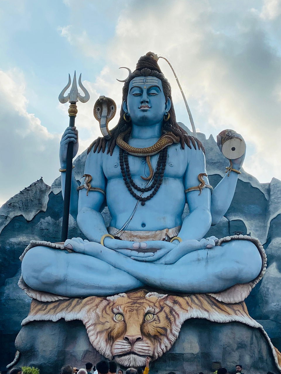 Blue Shiva meditating on a tiger skin.
