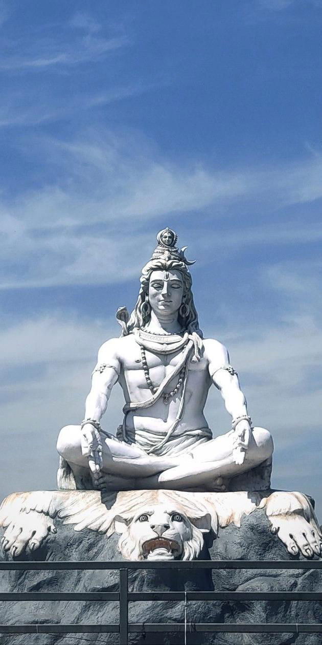 Meditating Shiva statue overlooking mountains